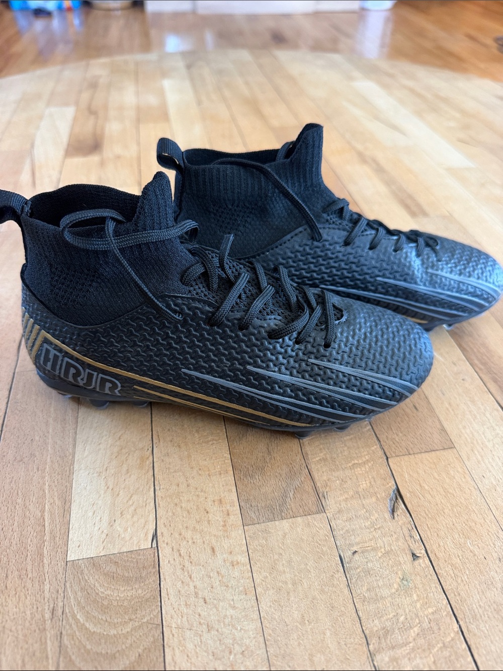 Black High-Top Boys Soccer Cleats with Gold Accents
